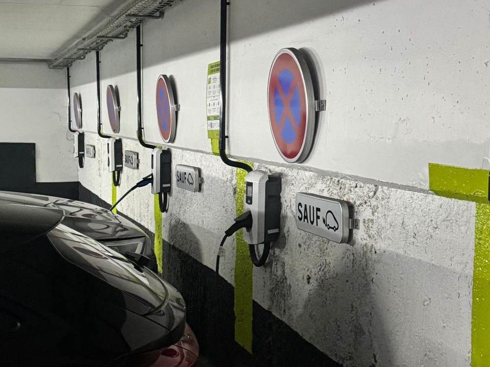 Row of wall-mounted EV chargers installed by D-Voltaris in a covered car park